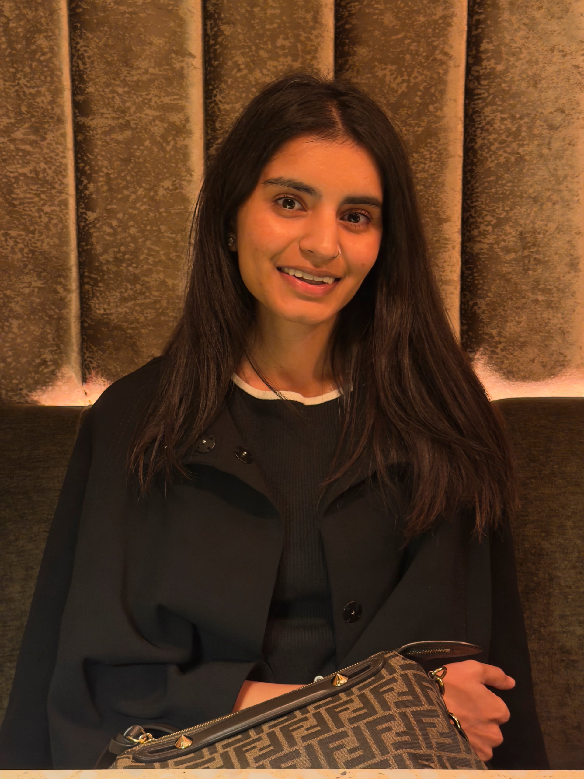 Ashni, founder of Cakes by Ashni, smiling in a portrait in Woodbridge, New Jersey