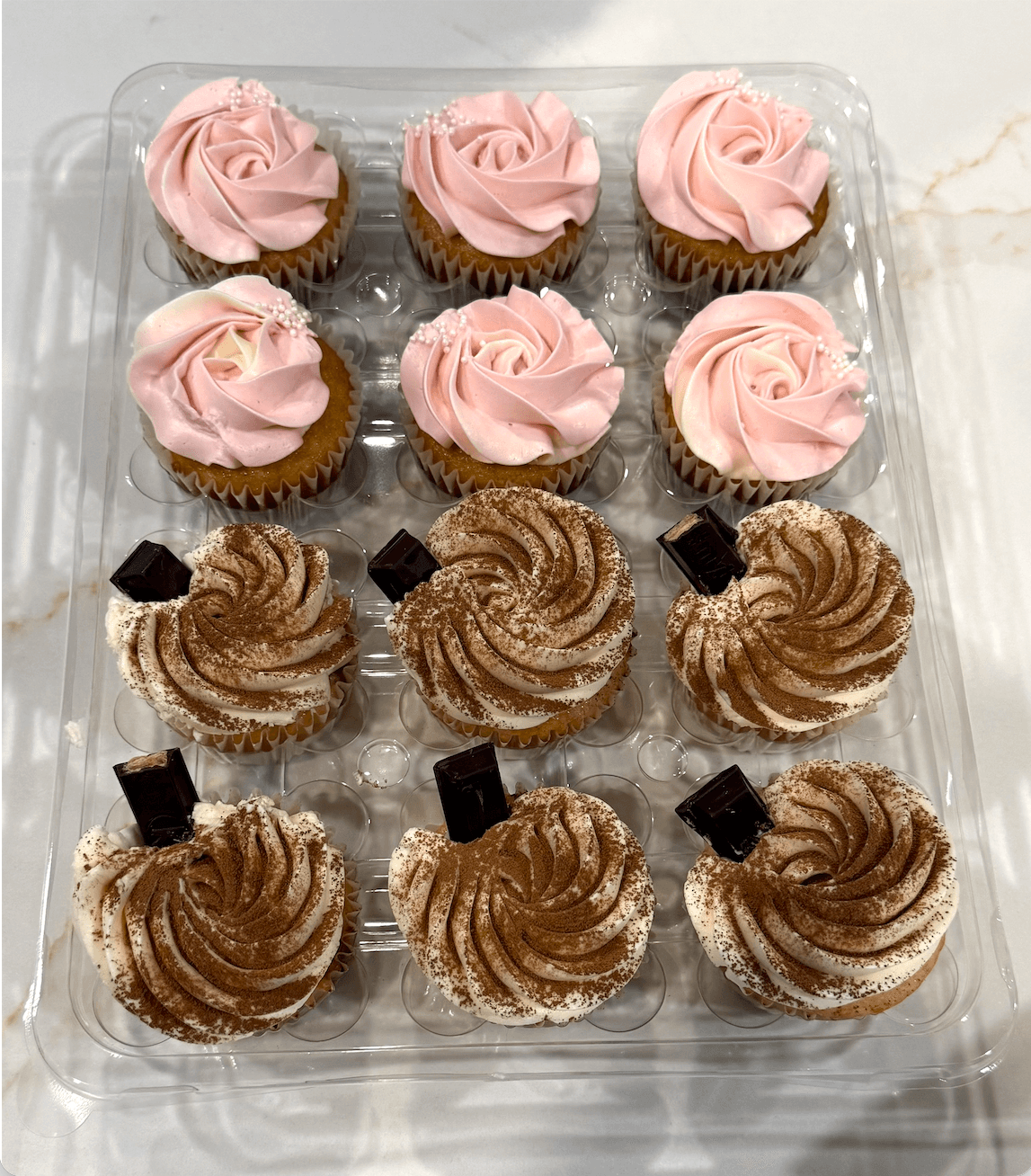 Elegant tiramisu cupcakes dusted with cocoa and beautifully presented, made by Cakes by Ashni in New Jersey
