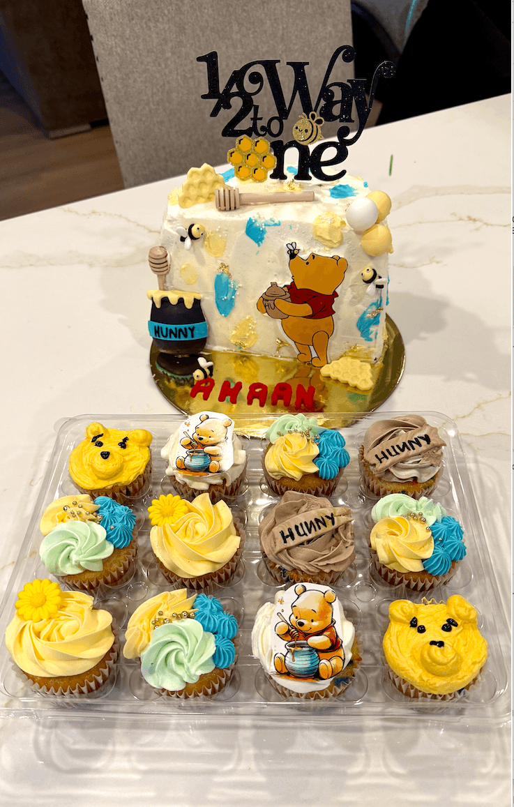 Custom Winnie the Pooh themed birthday cake with hand-painted characters, made by Cakes by Ashni in NJ